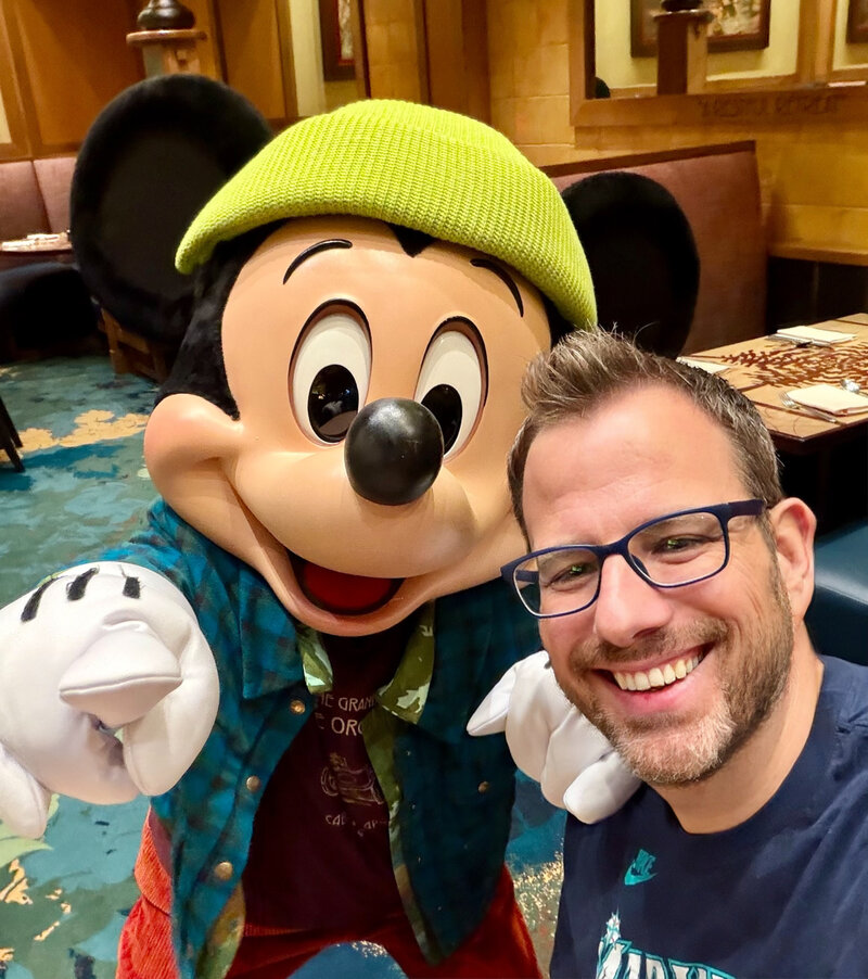 Greg with Mickey Mouse at Disney